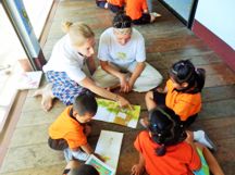 english volunteers with children on mobile library visit